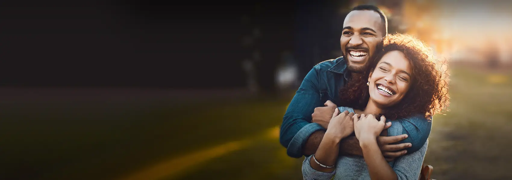 Two people hugging and smilin